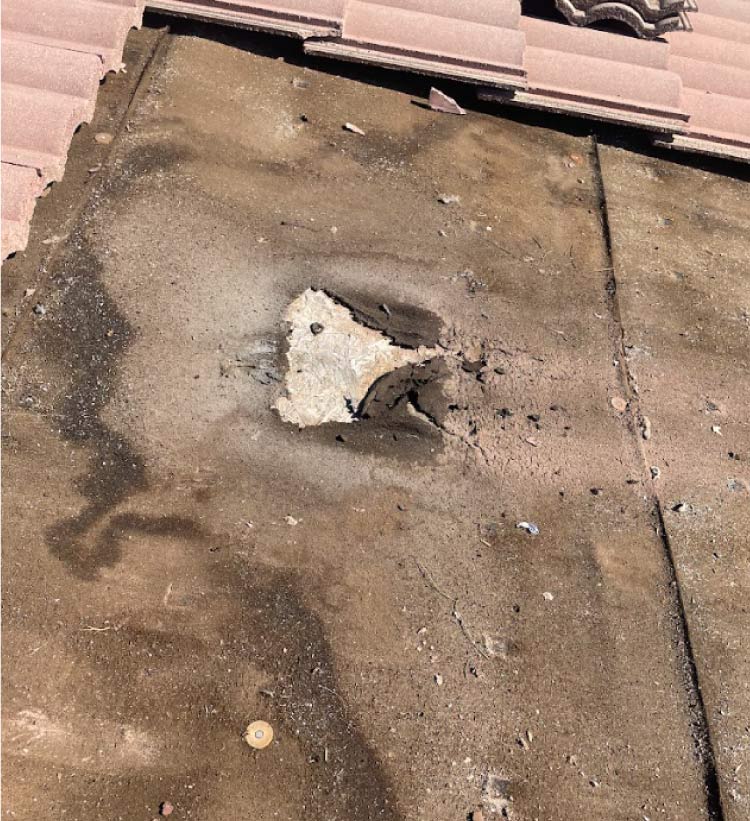 broken tile roof with a leak being repaired by the expert roofing company in hemet, ca