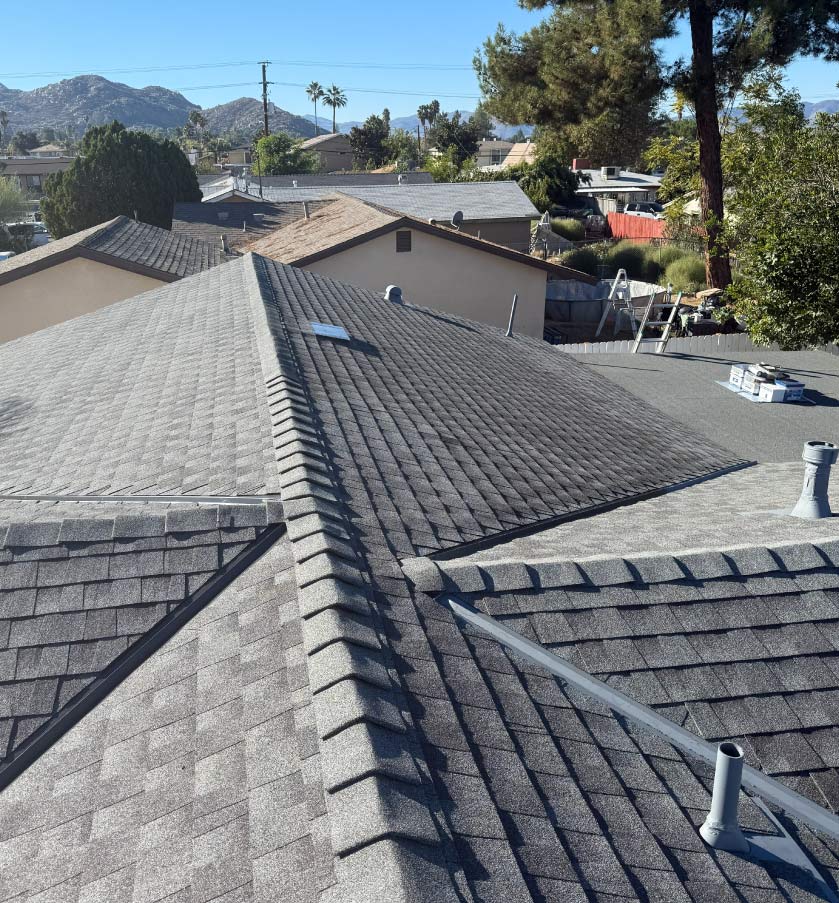 Roof leak repair process involving the removal of damaged shingles and replacement of rotted wood decking.